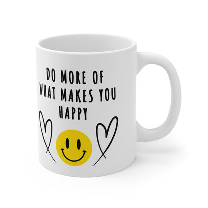 11 oz white ceramic mug with smiling emoji and hearts and 'Do More of What Makes You Happy' in bold black letters, uplifting and motivational design