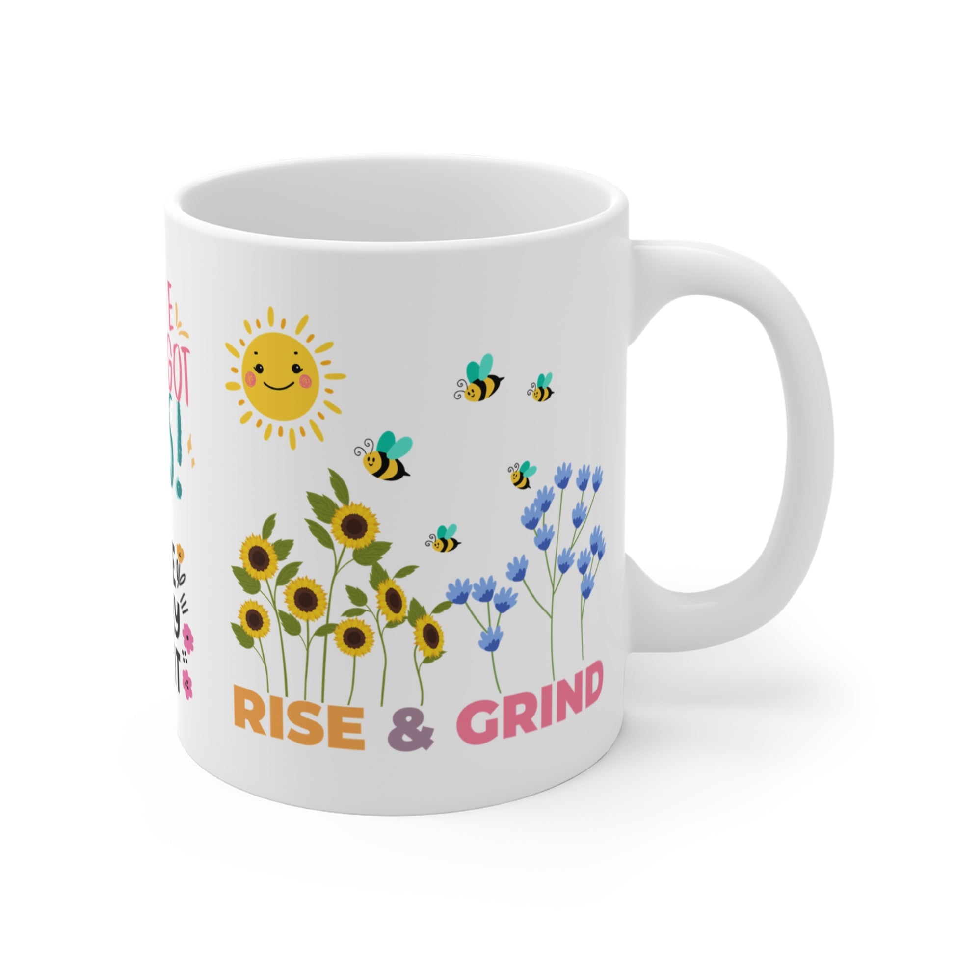 11 oz white ceramic mug with 'Rise & Grind' in bold colorful letters and a graphic of smiling sun, colorful flowers and bees, uplifting and motivational design