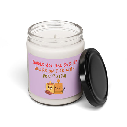 A soy candle in a 9oz in a glass jar with a phrase 'Candle You Believe It' on the label, featuring graphic of two smiling candles