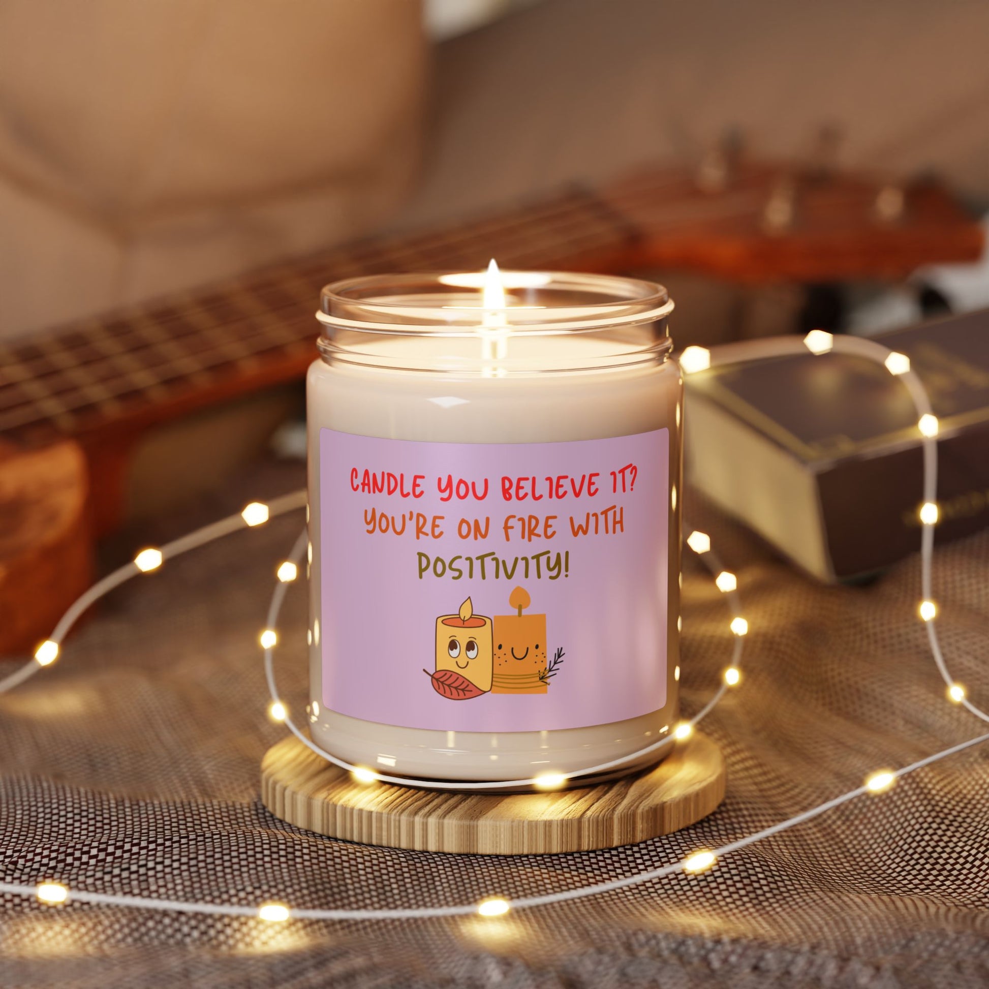 A soy candle in a 9oz in a glass jar with a phrase 'Candle You Believe It' on the label, featuring graphic of two smiling candles