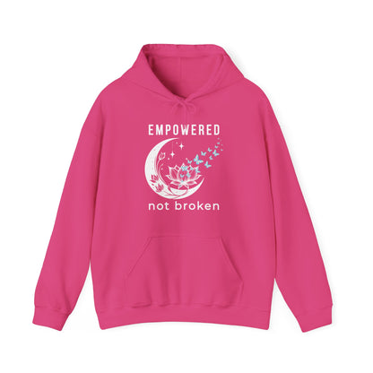 a pink unisex hoodie with text 'empowered not broken', featuring a moon and lotus with little flying butterflies