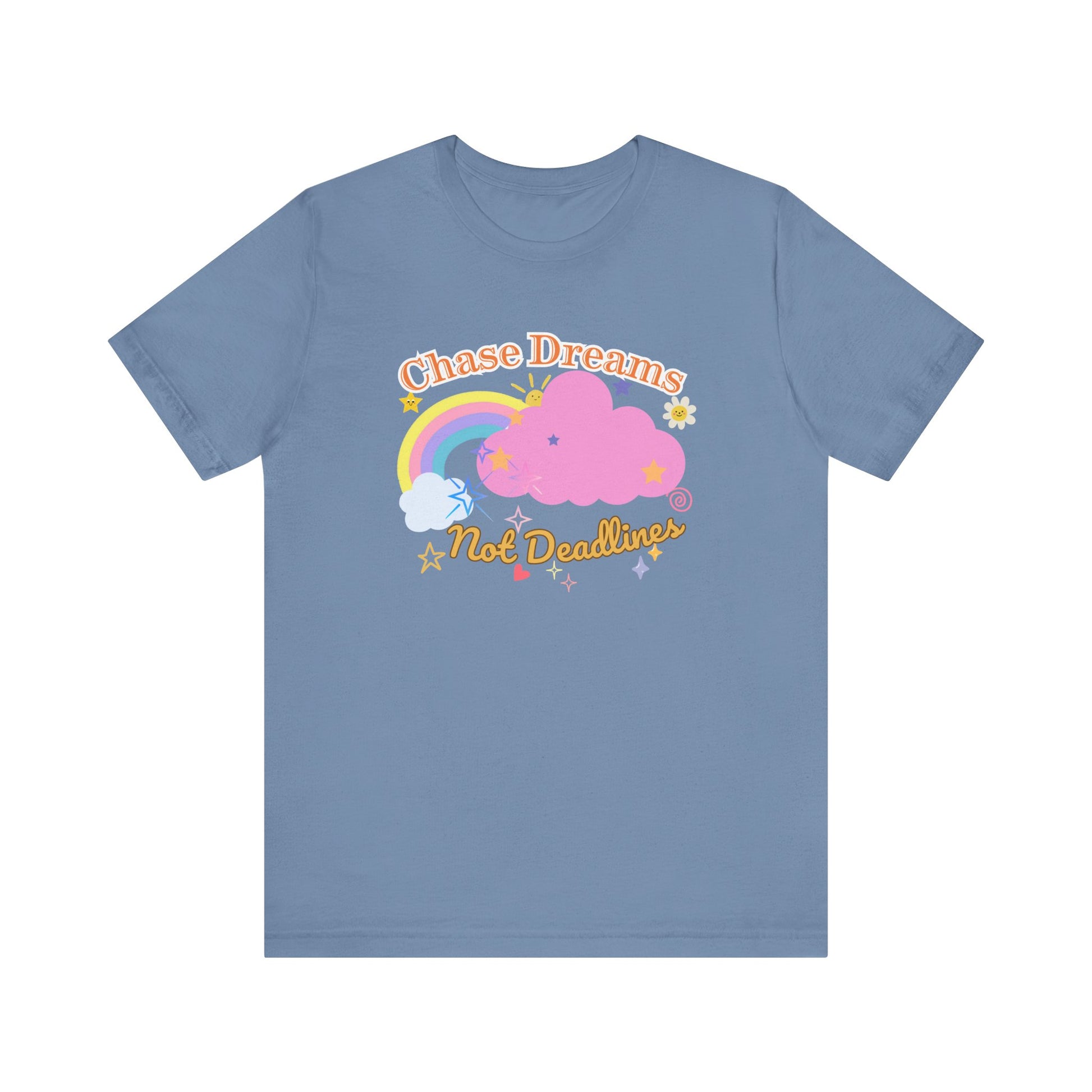 A steel blue unisex graphic t-shirt with the phrase 'Chase Dreams, Not Deadlines' in bold lettering, featuring a rainbow and soft pink cloud